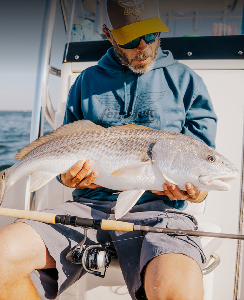 Man on boat with large fish caught with a Fenwick rod