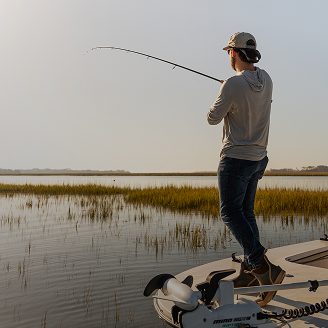 Landscape view of man fishing inshore | Fenwick